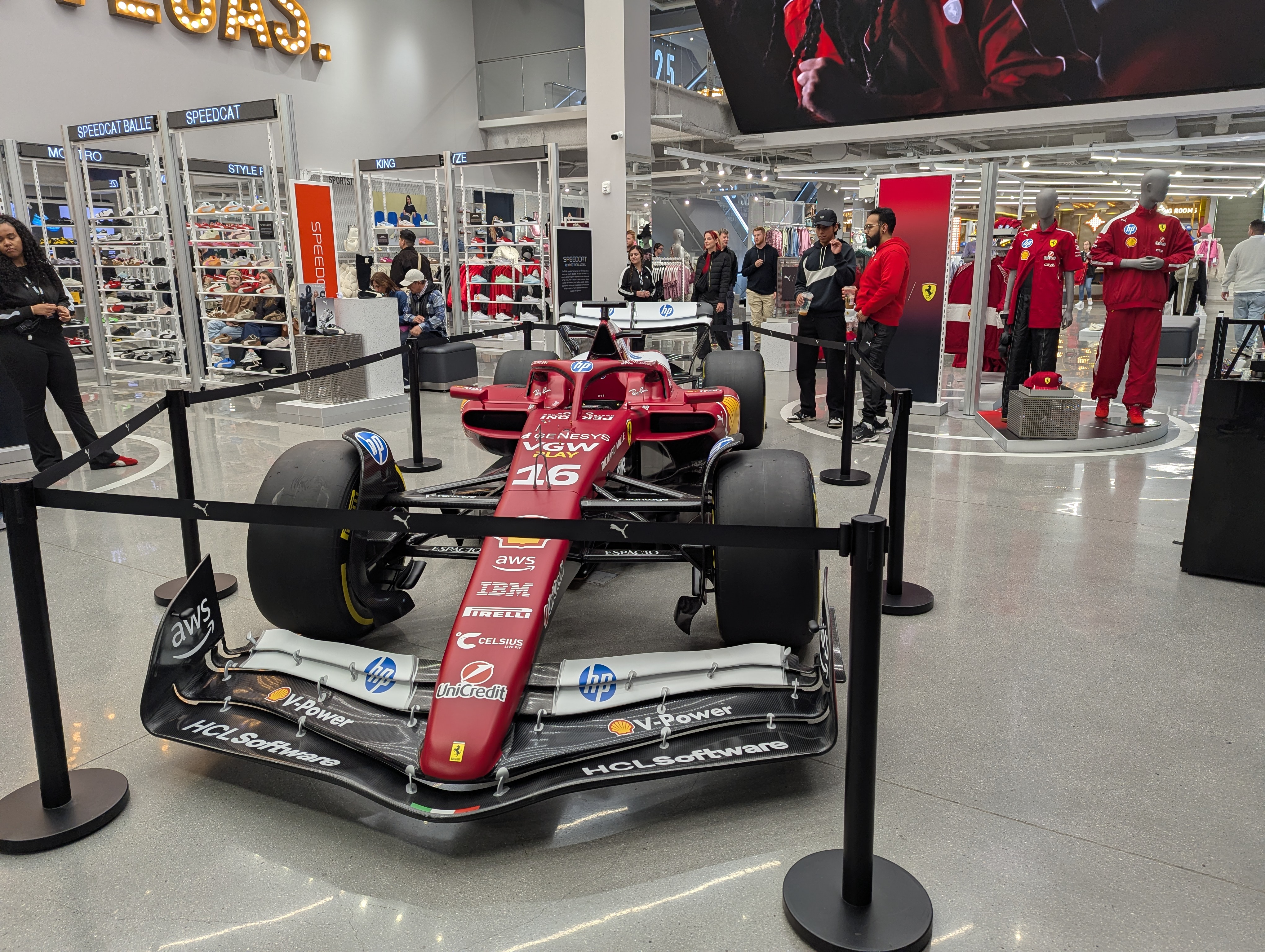 Red Formula 1 car displayed in a Ferrari retail store